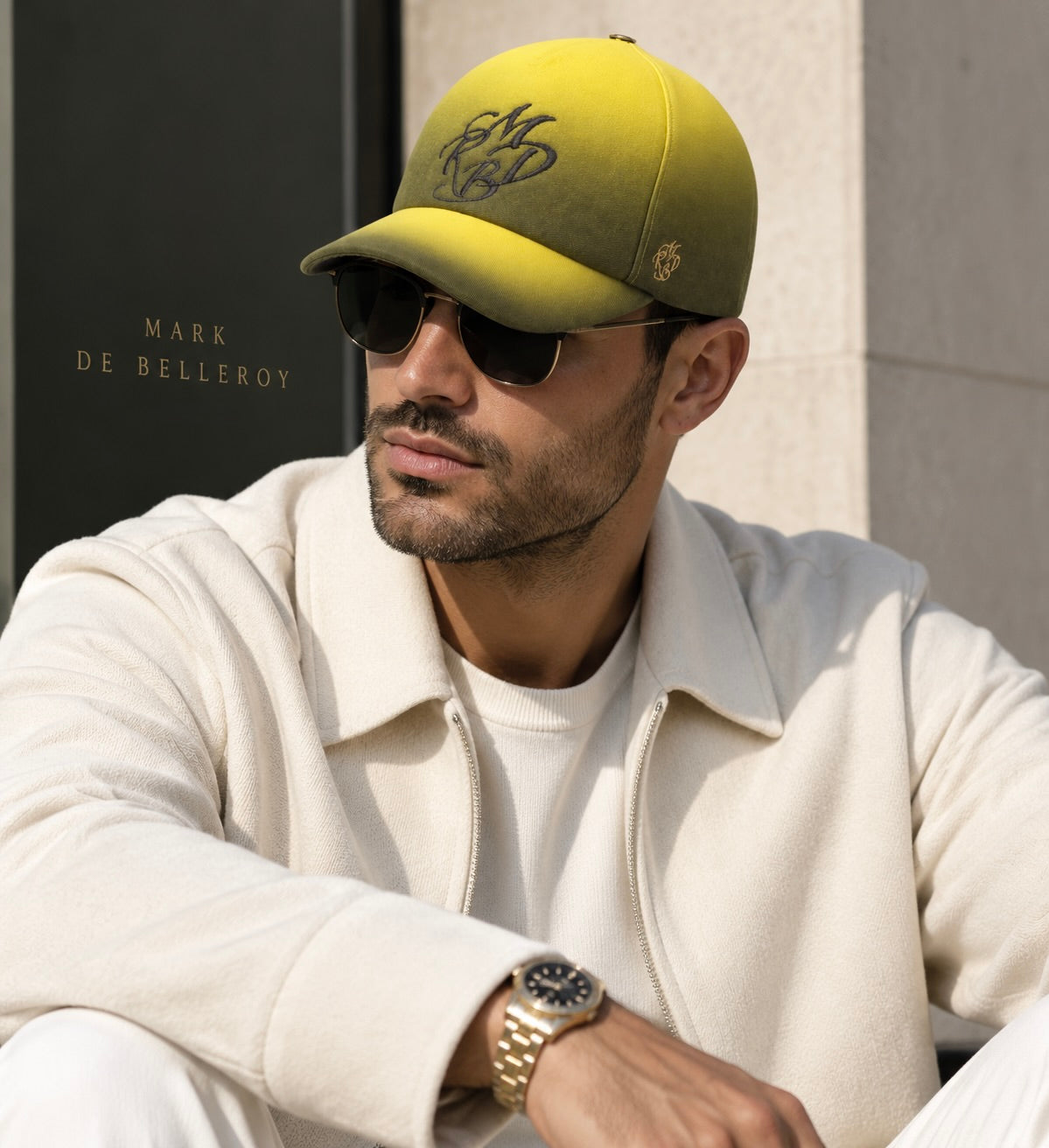 man wearing the yellow and black L'Aurore Nocturne baseball cap Mark De Belleroy