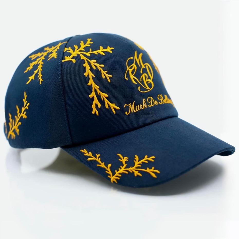 Casquette de luxe bleu marine branchage orange profil avant gauche rivet argenté collection Prestige Mark De Belleroy

